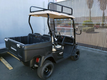 Black utility golf cart equipped with a LAD-SWIV-BRKT SWIVEL SIDE-MOUNT LADDER RACK mounted on the roof, designed for custom fabrication for golf carts to carry ladders and cargo.