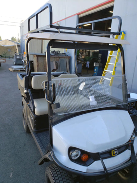 Golf cart equipped with a LAD-SWIV-BRKT SWIVEL SIDE-MOUNT LADDER RACK, demonstrating custom fabrication for golf carts designed to hold ladders and cargo securely.