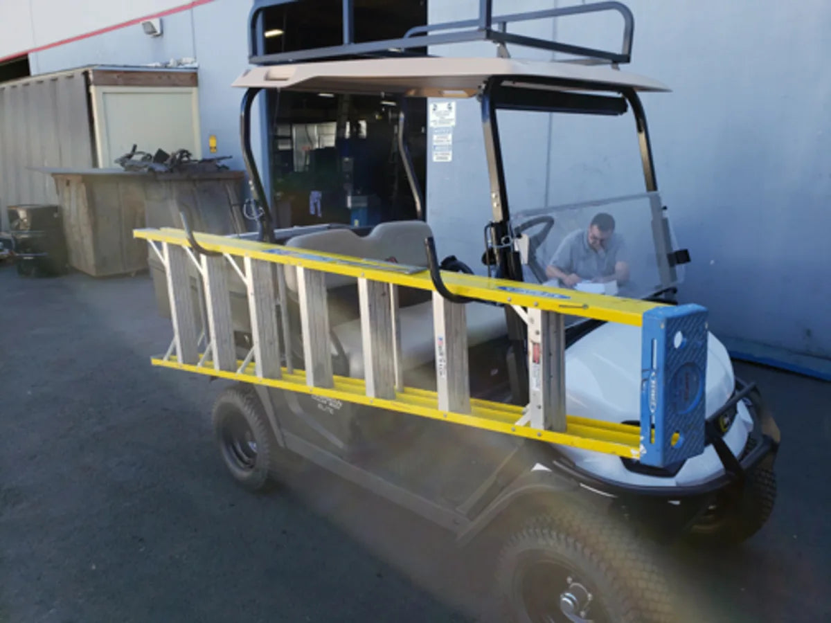 LAD-SWIV-BRKT SWIVEL SIDE-MOUNT LADDER RACK mounted on a golf cart holding a yellow ladder, designed for custom fabrication and transporting ladders and equipment safely.