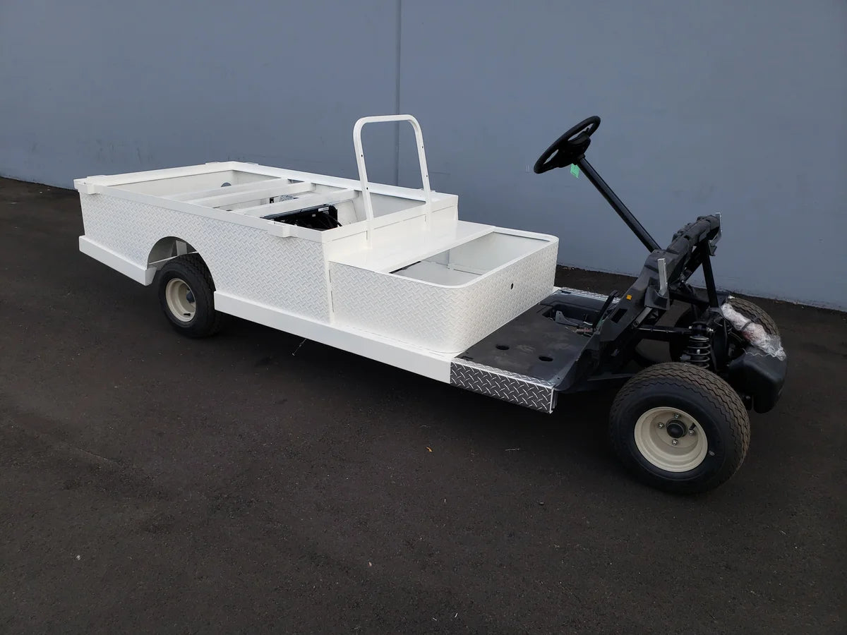 Custom fabricated white utility golf cart with flatbed and stake pockets, featuring STAKEBED POCKETS FOR 6 FT FLATBED DECK CONVERSION for enhanced cargo carrying capacity.