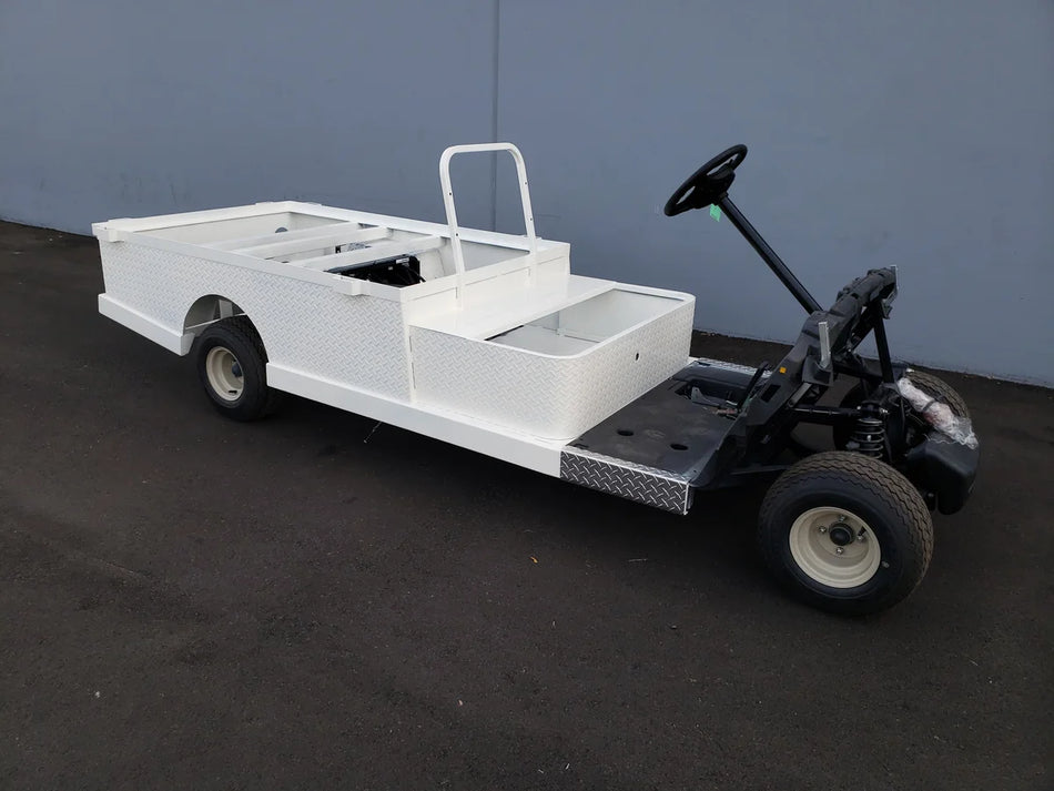 Custom fabricated white utility golf cart with flatbed and stake pockets, featuring STAKEBED POCKETS FOR 6 FT FLATBED DECK CONVERSION for enhanced cargo carrying capacity.