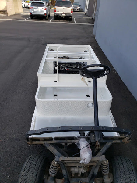 White flatbed cart with steel frame and steering wheel, showcasing YAM-DRIVE-ST-FLAT-72 YAMAHA DRIVE CART STRETCH INTO STEEL 6′ FLATBED, custom fabrication for golf carts.