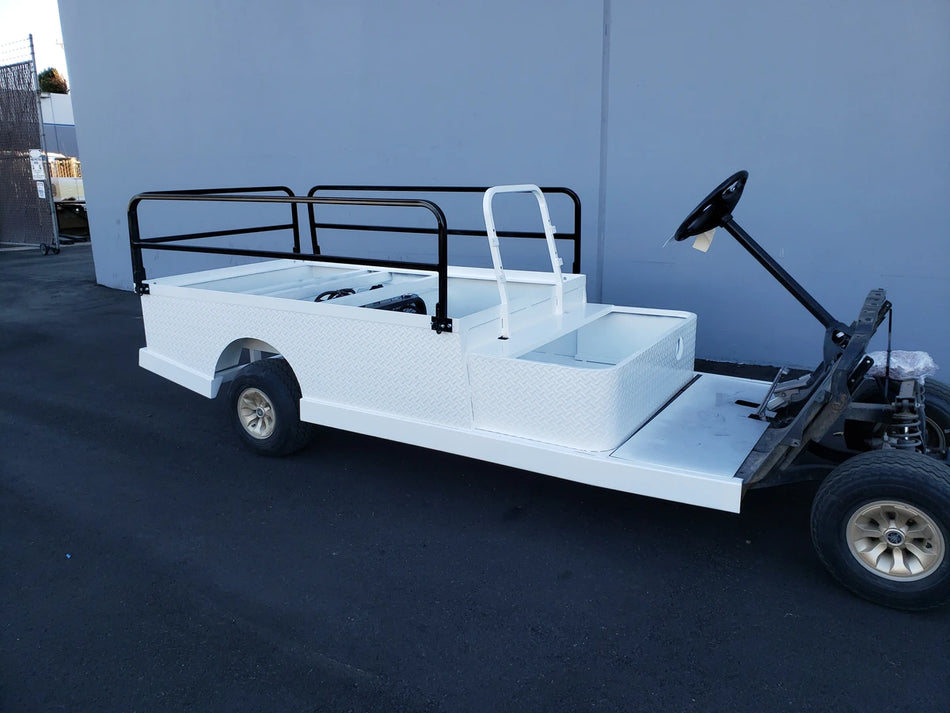 A white utility golf cart with DROP RAILS 44″ X 72″ X 18″ FLATBED SIDE RAILS FOR 6 FT FLATBED CONVERSION installed, featuring custom fabrication for golf carts.