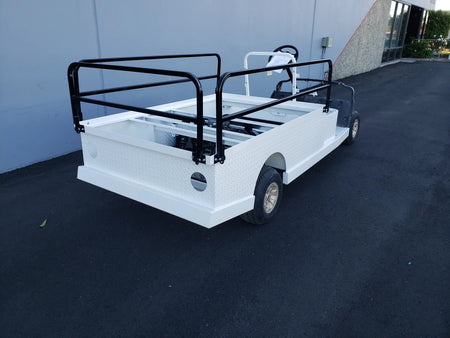 DROP RAILS 44″ X 72″ X 18″ FLATBED SIDE RAILS FOR 6 FT FLATBED CONVERSION installed on a golf cart flatbed, showcasing custom fabrication for golf carts with black metal side rails and white flatbed cargo area.