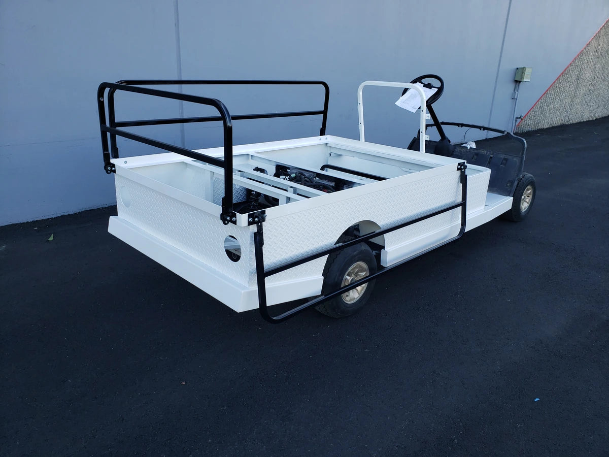 White flatbed golf cart with black DROP RAILS 44″ X 72″ X 18″ FLATBED SIDE RAILS FOR 6 FT FLATBED CONVERSION installed, custom fabricated for golf carts, suitable for cargo and utility use.