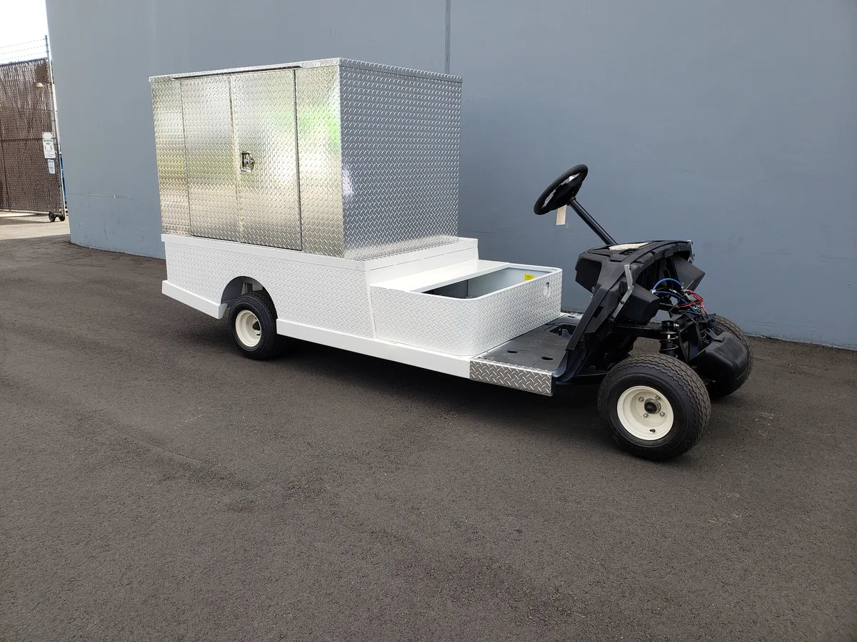 FMB-44X72X48-S-D3W0 FLATBED ALUMINUM SMOOTH MULTI-PURPOSE BOX 44″ WIDE X 72″ LONG X 48″ TALL WITH LOCKING DOORS mounted on a custom fabrication for golf carts, featuring flatbed utility cargo storage.