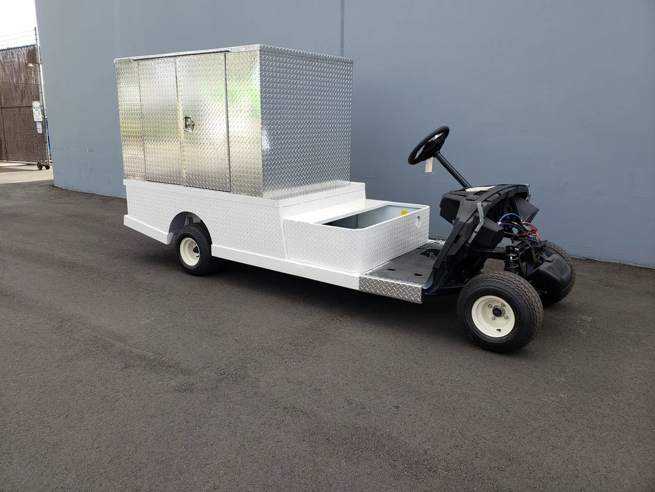 FMB-44X72X48-S-D3W0 FLATBED ALUMINUM SMOOTH MULTI-PURPOSE BOX 44″ WIDE X 72″ LONG X 48″ TALL WITH LOCKING DOORS mounted on a custom fabrication for golf carts, featuring flatbed utility cargo storage.