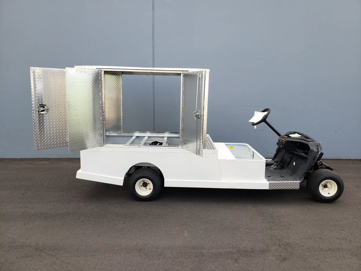 FMB-44X72X48-S-D3W0 FLATBED ALUMINUM SMOOTH MULTI-PURPOSE BOX 44″ WIDE X 72″ LONG X 48″ TALL WITH LOCKING DOORS mounted on a custom golf cart flatbed for utility and cargo transport.
