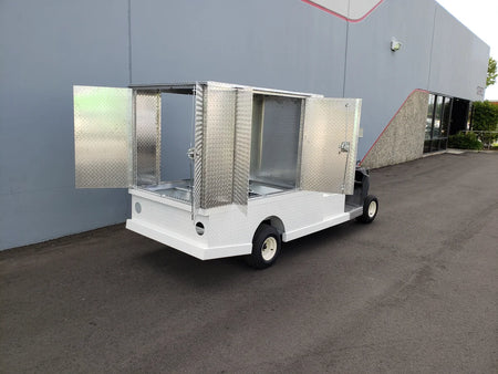 FMB-44X72X48-S-D3W0 FLATBED ALUMINUM SMOOTH MULTI-PURPOSE BOX 44″ WIDE X 72″ LONG X 48″ TALL WITH LOCKING DOORS mounted on a golf cart, featuring custom fabrication for golf carts and designed for cargo and utility storage.