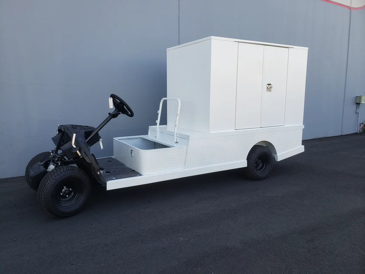White flatbed utility vehicle featuring the FMB-44X72X48-S-D2W0 FLATBED ALUMINUM SMOOTH MULTI-PURPOSE BOX with custom fabrication for golf carts and storage compartments.