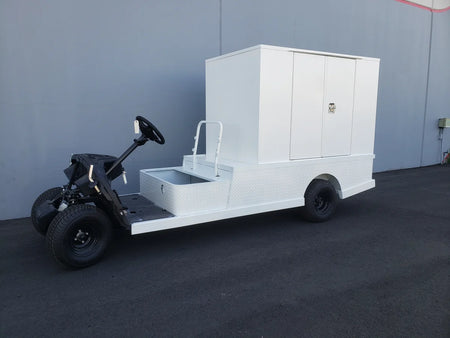 White flatbed utility vehicle featuring the FMB-44X72X48-S-D2W0 FLATBED ALUMINUM SMOOTH MULTI-PURPOSE BOX with custom fabrication for golf carts and storage compartments.