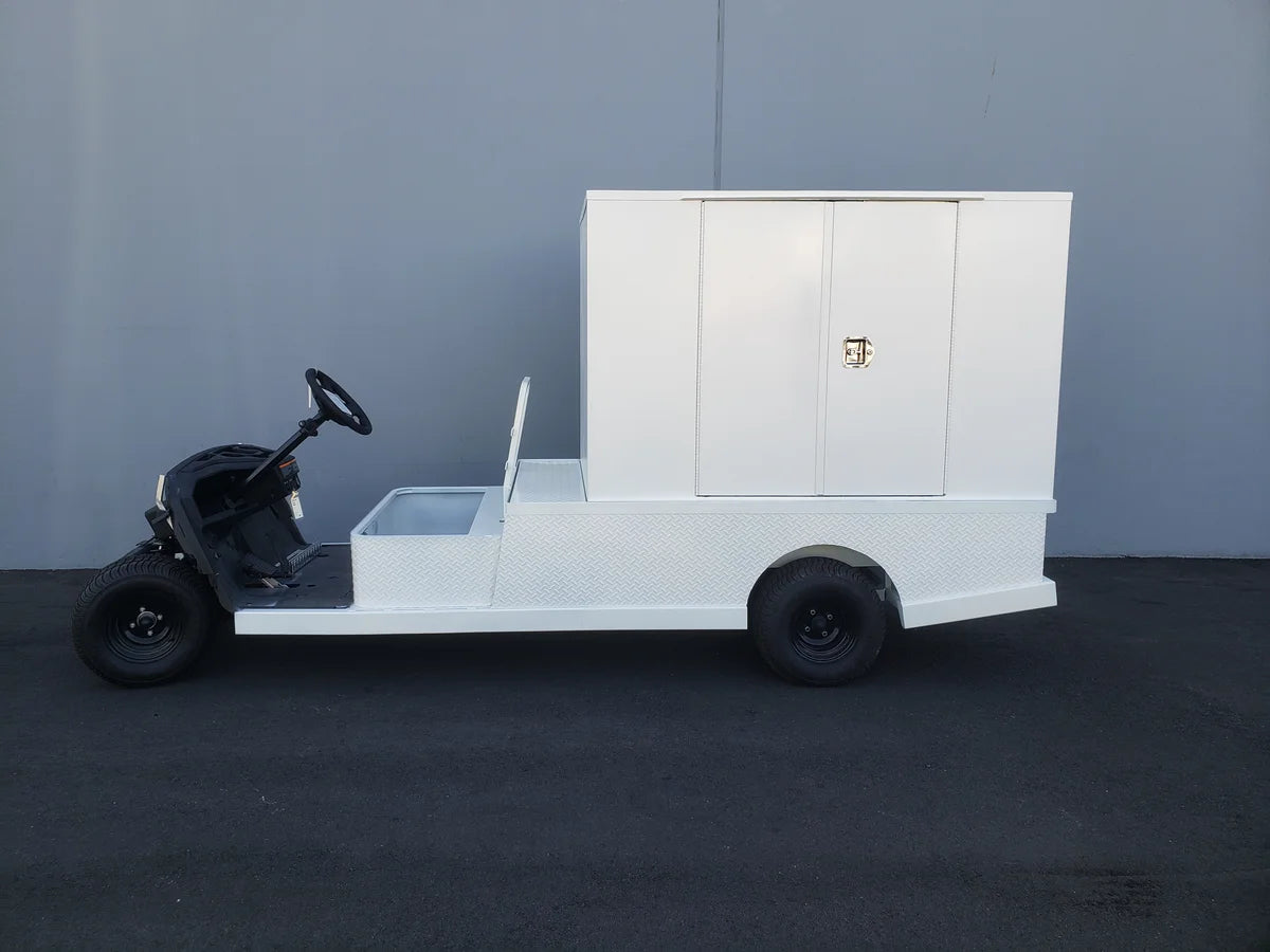 Golf cart outfitted with FMB-44X72X48-S-D2W0 FLATBED ALUMINUM SMOOTH MULTI-PURPOSE BOX in white, custom fabricated for golf carts to provide secure cargo and utility storage.