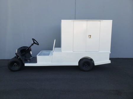 Golf cart outfitted with FMB-44X72X48-S-D2W0 FLATBED ALUMINUM SMOOTH MULTI-PURPOSE BOX in white, custom fabricated for golf carts to provide secure cargo and utility storage.