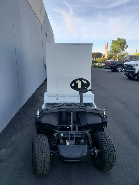 A golf cart fitted with a custom fabricated FMB-44X72X48-D-D2W0 FLATBED ALUMINUM DIAMOND PLATE MULTI-PURPOSE BOX, designed for versatile cargo and utility use.