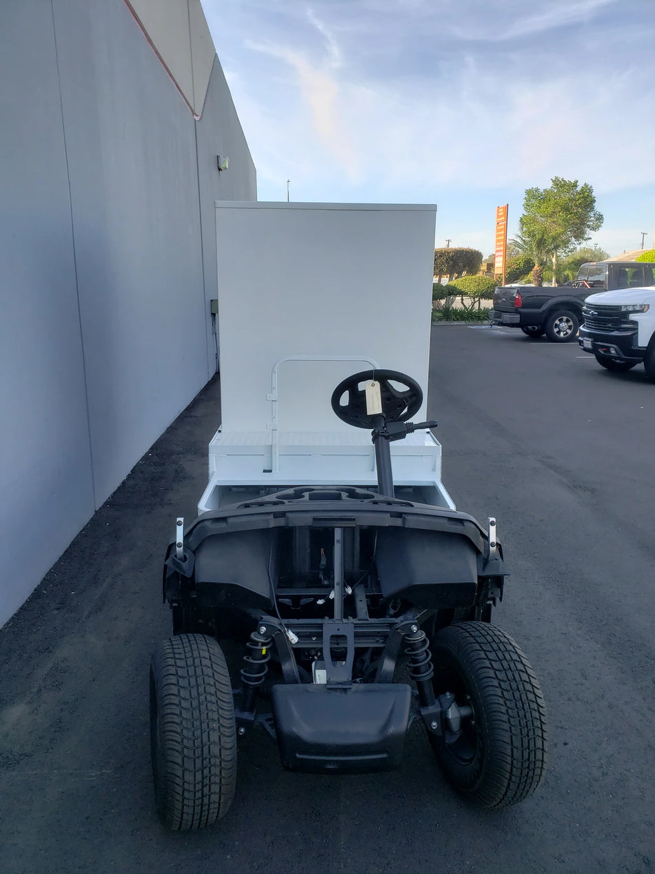 A golf cart fitted with a custom fabricated FMB-44X72X48-D-D2W0 FLATBED ALUMINUM DIAMOND PLATE MULTI-PURPOSE BOX, designed for versatile cargo and utility use.