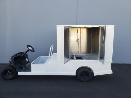 White flatbed utility cart with an open FMB-44X72X48-D-D2W0 FLATBED ALUMINUM DIAMOND PLATE MULTI-PURPOSE BOX featuring double doors, custom fabrication for golf carts.