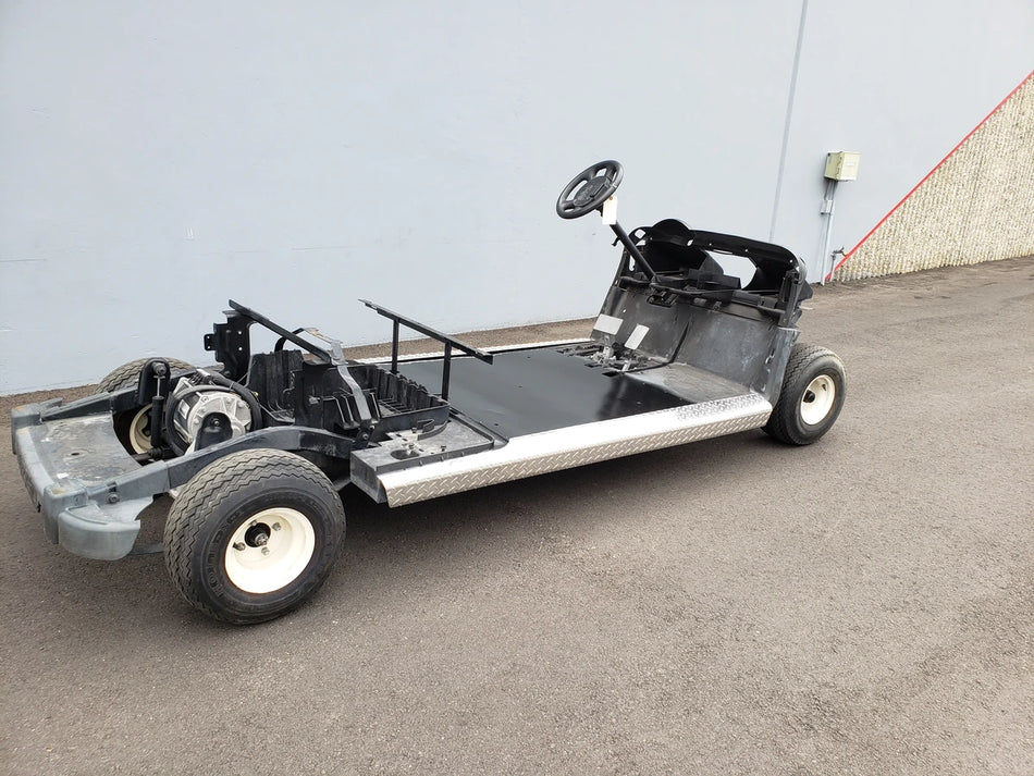 EZGO-RXV-PS6-4F+2B EZGO RXV 6 PASSENGER CONVERSION golf cart frame showcasing custom fabrication with visible chassis, steering wheel, and seating base for golf cart modification.