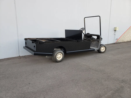 EZGO-RXV-ST-FLAT-72 EZ GO RXV FLATBED RETROFIT CONVERSION showing a custom-fabricated black flatbed attached to a golf cart for enhanced cargo utility and durability.