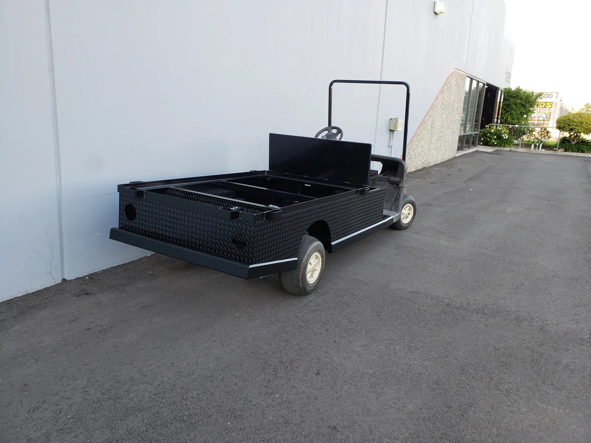 EZGO-RXV-ST-FLAT-72 EZ GO RXV FLATBED RETROFIT CONVERSION showing a custom fabricated black flatbed utility conversion designed for golf carts, emphasizing robust cargo hauling functionality.