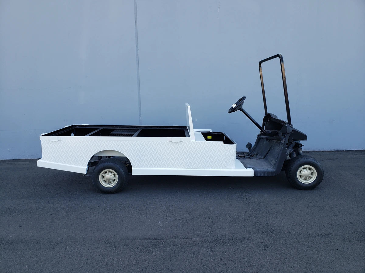 EZGO-RXV-ST-FLAT-72 EZ GO RXV FLATBED RETROFIT CONVERSION golf cart with custom fabrication, featuring a durable flatbed utility cargo area designed for enhanced functionality.
