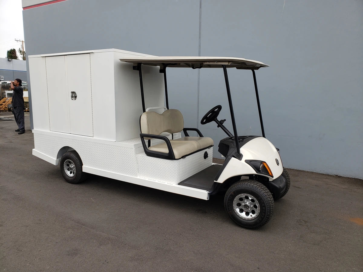 Utility golf cart equipped with FMB-44X72X48-D-D2W0 FLATBED ALUMINUM DIAMOND PLATE MULTI-PURPOSE BOX, featuring custom fabrication for golf carts, ideal for cargo and specialty transport.