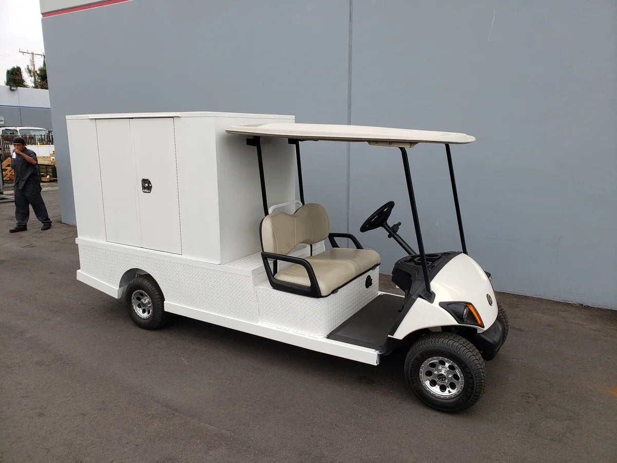 Golf cart equipped with FMB-44X72X48-S-D2W0 FLATBED ALUMINUM SMOOTH MULTI-PURPOSE BOX for custom fabrication, ideal for cargo and utility transport.