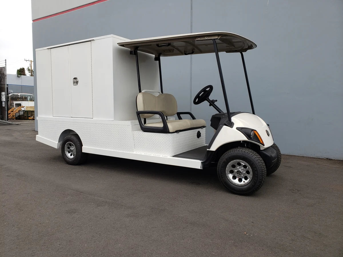 Golf cart equipped with FMB-44X72X48-S-D2W0 FLATBED ALUMINUM SMOOTH MULTI-PURPOSE BOX, custom fabrication for golf carts, designed for cargo and utility purposes.