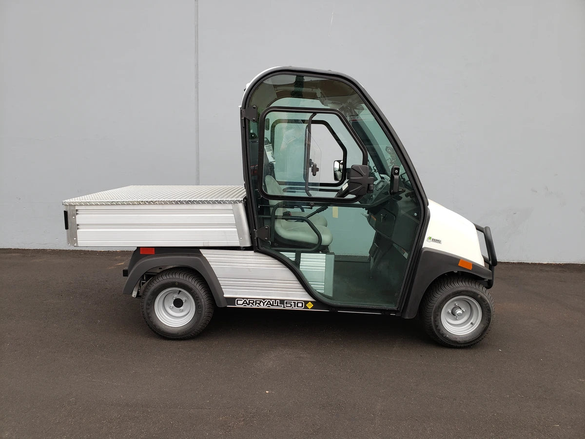 White utility cart with enclosed cabin and flatbed cargo area, featuring the CC-510-UTILITYBOX-LID CLUB CAR 510 UTILITY BOX SOLID LOCKING LID RETROFIT for secure storage and transport.