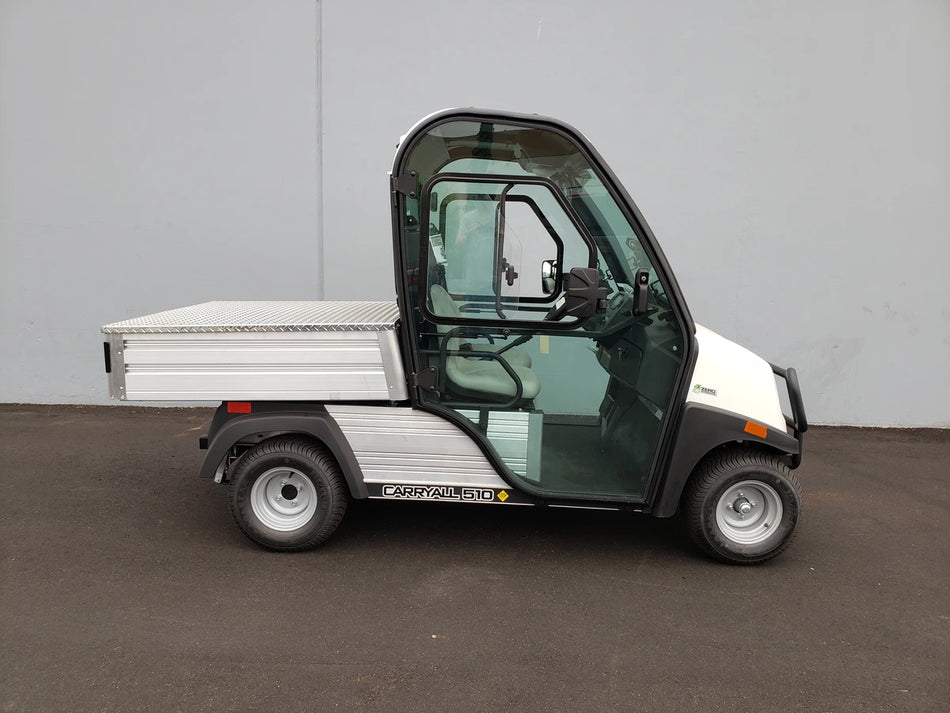 White utility cart with enclosed cabin and flatbed cargo area, featuring the CC-510-UTILITYBOX-LID CLUB CAR 510 UTILITY BOX SOLID LOCKING LID RETROFIT for secure storage and transport.