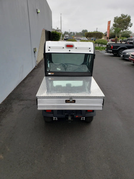 Rear view of a utility golf cart equipped with a CC-510-UTILITYBOX-LID CLUB CAR 510 UTILITY BOX SOLID LOCKING LID RETROFIT featuring a durable diamond plate cover suitable for cargo and utility transport.