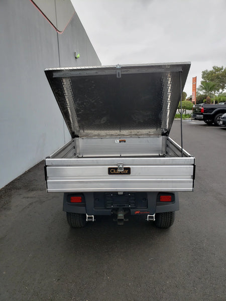 Rear view of a utility cart with the CC-510-UTILITYBOX-LID CLUB CAR 510 UTILITY BOX SOLID LOCKING LID RETROFIT open, showing a sturdy aluminum cargo bed designed for secure storage and transport.