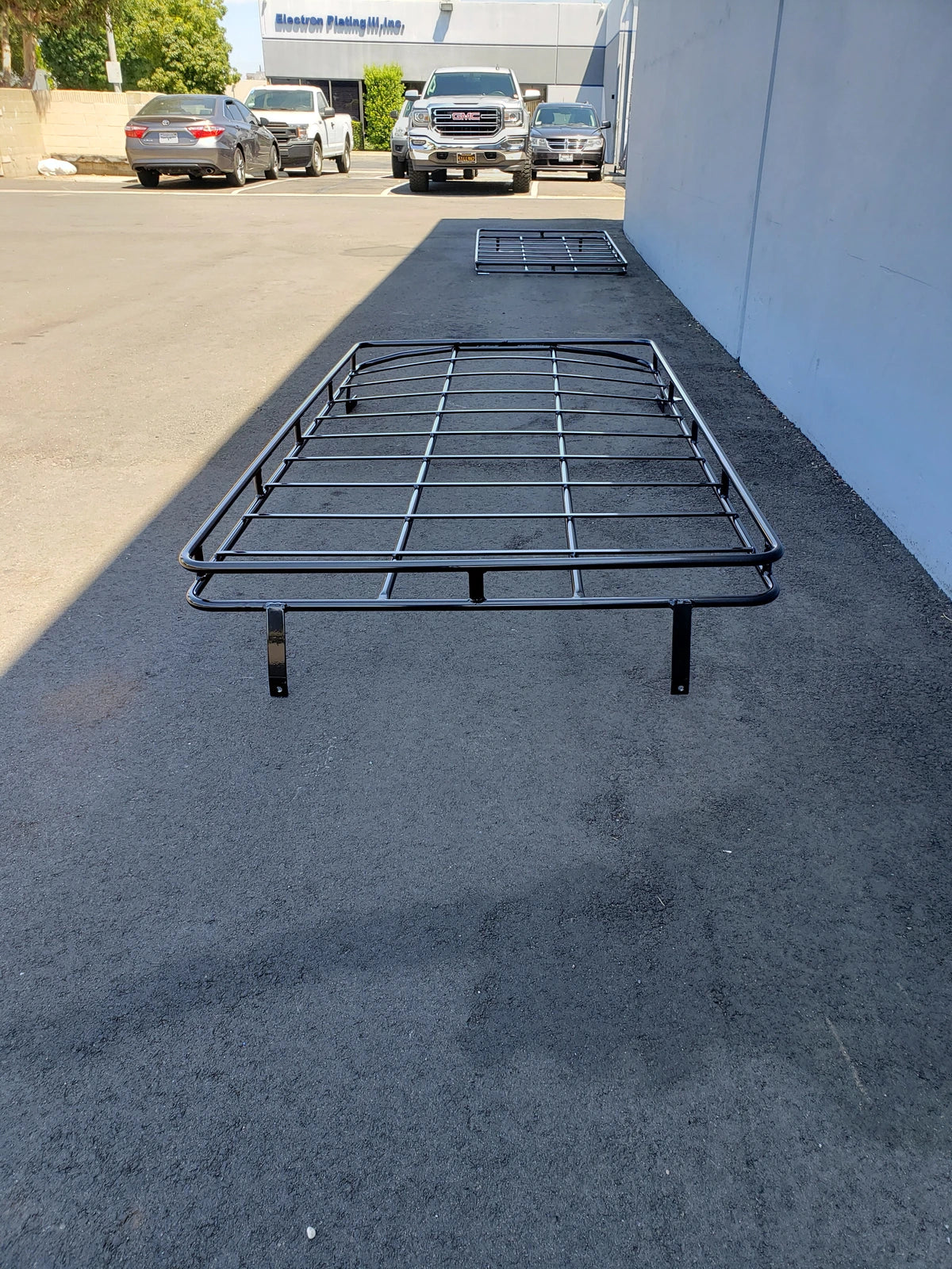 EZGO-S6CURVED-84RR3 ROOF RACK FITS EZ GO EXPRESS S6 SHADE TOP displayed outdoors on pavement with custom fabrication for golf carts, designed as a durable cargo rack accessory.