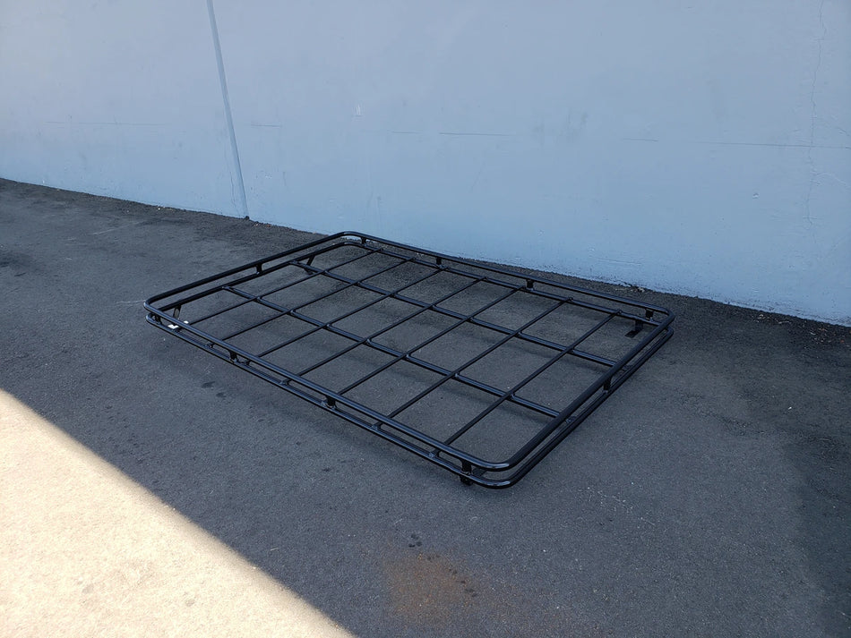 EZGO-S4CURVED-64RR3 ROOF RACK FOR EZ GO EXPRESS S4 shown on pavement, custom fabrication for golf carts, designed for cargo and utility transport with durable metal construction.