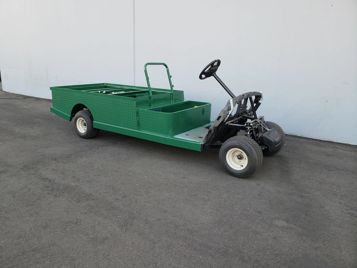 Green custom fabricated golf cart with EZGO-TXT-ST-FLAT-72 6 FT FLATBED CONVERSION FOR EZ GO TXT featuring a flatbed for cargo and utility transport.