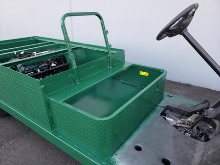 Green metal flatbed conversion with diamond plate texture and open cargo area installed on golf cart chassis, showcasing EZGO-TXT-ST-FLAT-72 6 FT FLATBED CONVERSION FOR EZ GO TXT, custom fabrication for golf carts.