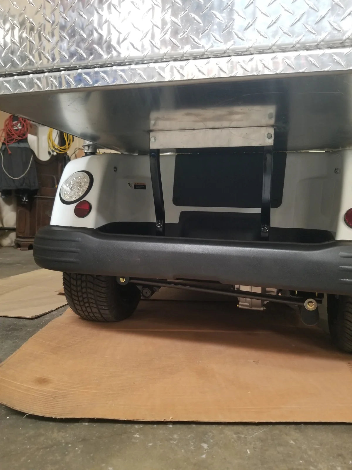 TOM-35X32X37-RB Tomberlin Emerge Rear Box installed on a golf cart showing the custom fabrication flatbed utility box with diamond plate surface and rear bumper detail.