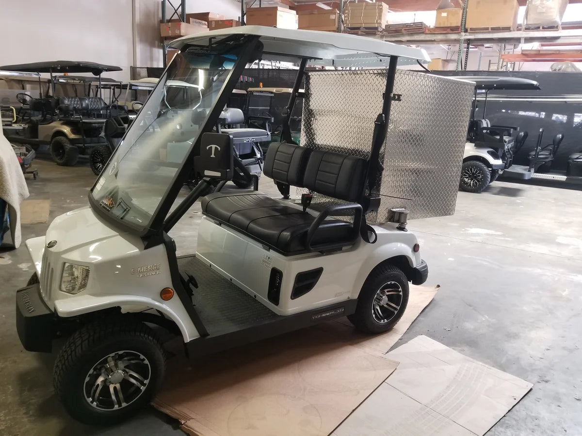 White golf cart equipped with a custom fabrication TOM-35X32X37-RB Tomberlin Emerge Rear Box utility box, designed for cargo and specialty golf cart beds.