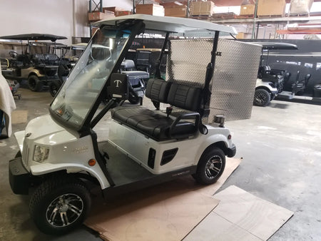 White golf cart equipped with a custom fabrication TOM-35X32X37-RB Tomberlin Emerge Rear Box utility box, designed for cargo and specialty golf cart beds.