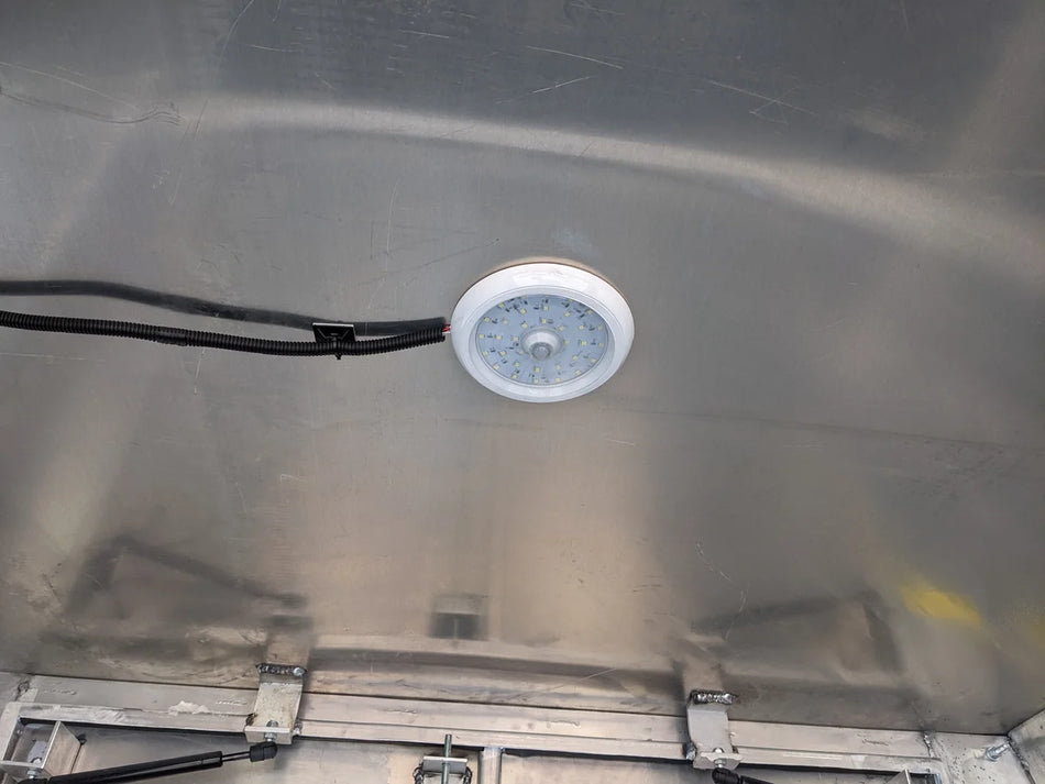Interior view of a metal flatbed box featuring the FMB-DOME LIGHT for Flatbed Multipurpose Box installed on the ceiling, showcasing custom fabrication for golf carts.