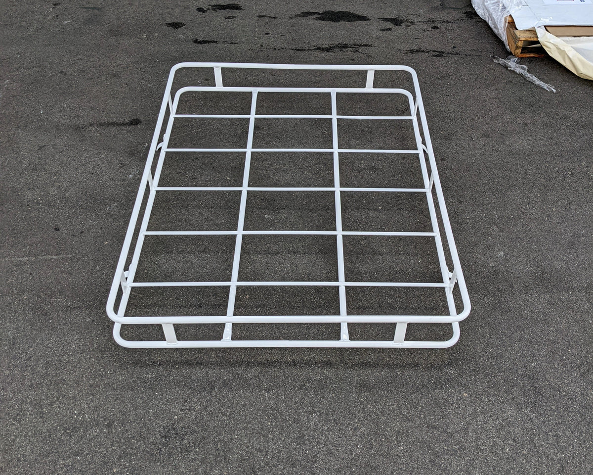 White metal roof rack designed for flat cargo support, displayed on asphalt surface, custom fabrication for golf carts, FORD-THINK-60RR6 FORD THINK ROOF RACK.