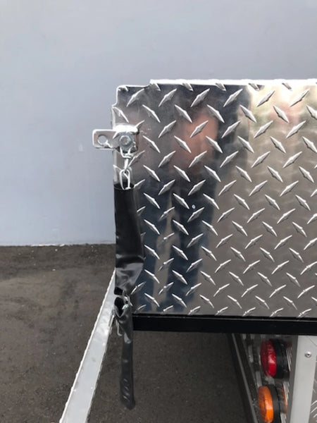 Close-up of diamond plate aluminum surface and latch mechanism on a TBA-48X46X19 ALUMINUM TILT BED FOR GOLF CART, showcasing custom fabrication for golf carts.