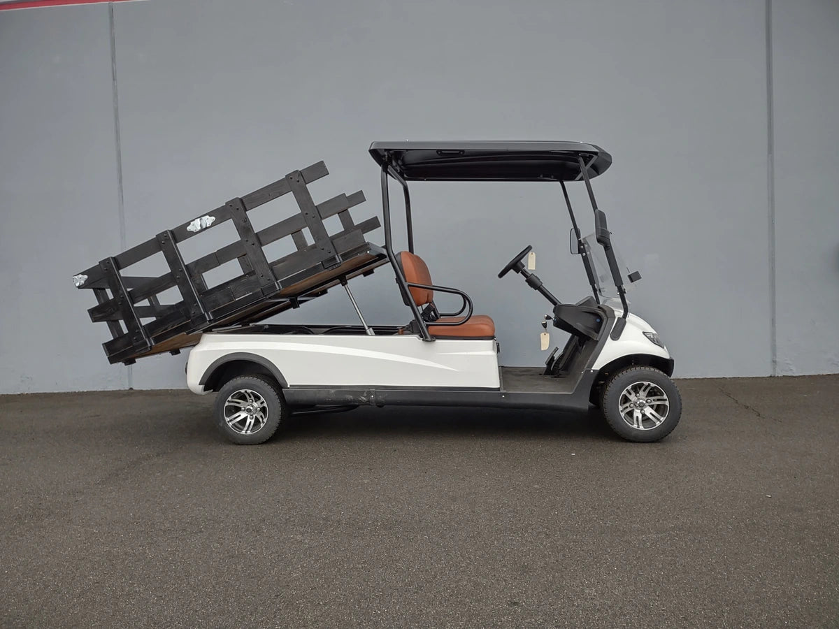 Golf cart equipped with a CRUISE-C20-DECK44X72-W WOOD FLATBED DECK in a raised position, custom fabrication for golf carts designed for cargo and utility use.