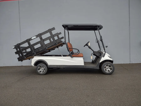 Golf cart equipped with a CRUISE-C20-DECK44X72-W WOOD FLATBED DECK in a raised position, custom fabrication for golf carts designed for cargo and utility use.