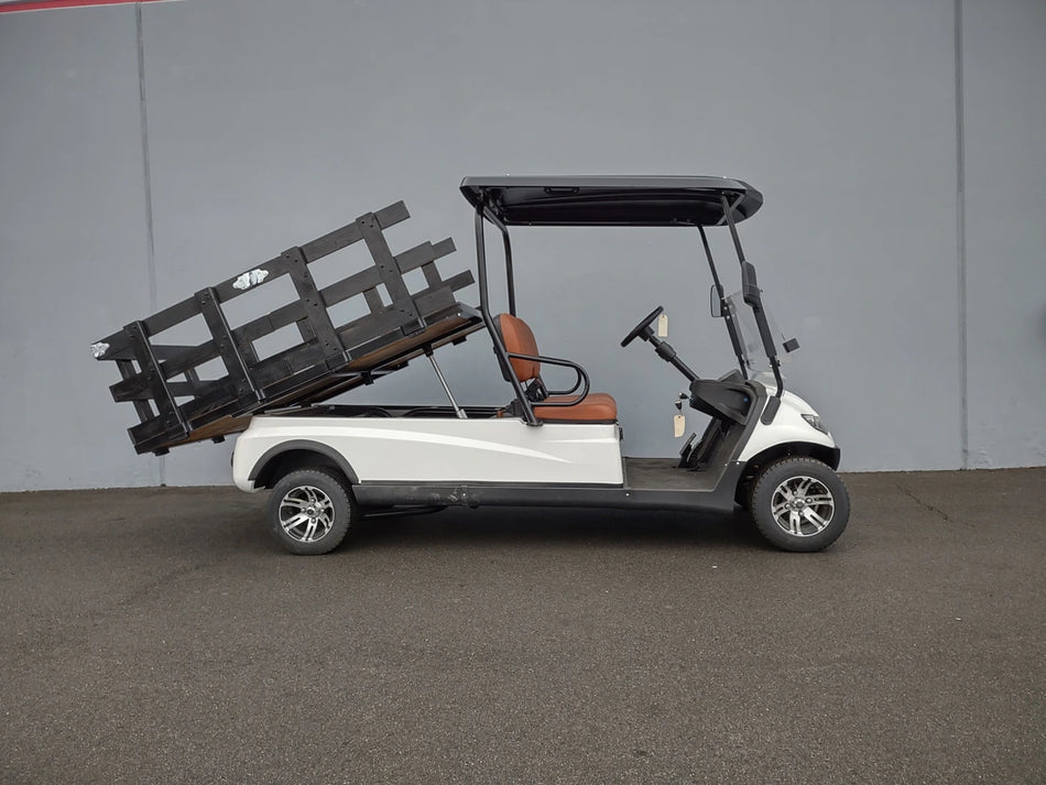 Golf cart equipped with a CRUISE-C20-DECK44X72-W WOOD FLATBED DECK in a raised position, custom fabrication for golf carts designed for cargo and utility use.