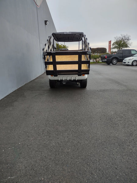 Rear view of a golf cart fitted with the CRUISE-C20-DECK44X72-W WOOD FLATBED DECK featuring a custom fabricated wood flatbed and side rails for enhanced cargo utility.