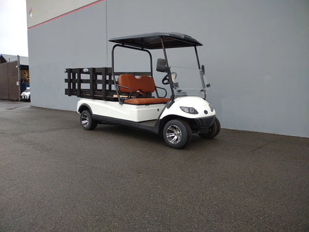 White golf cart fitted with a CRUISE-C20-DECK44X72-W WOOD FLATBED DECK featuring wooden side rails and brown seats, designed for custom fabrication for golf carts.