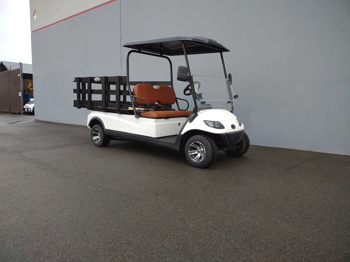 White golf cart with black stake sides on the flatbed for cargo, featuring custom fabrication for golf carts and STAЮЕК-SIDЕS-44X72X24 Flatbed Golf Cart Stake Sides installed.