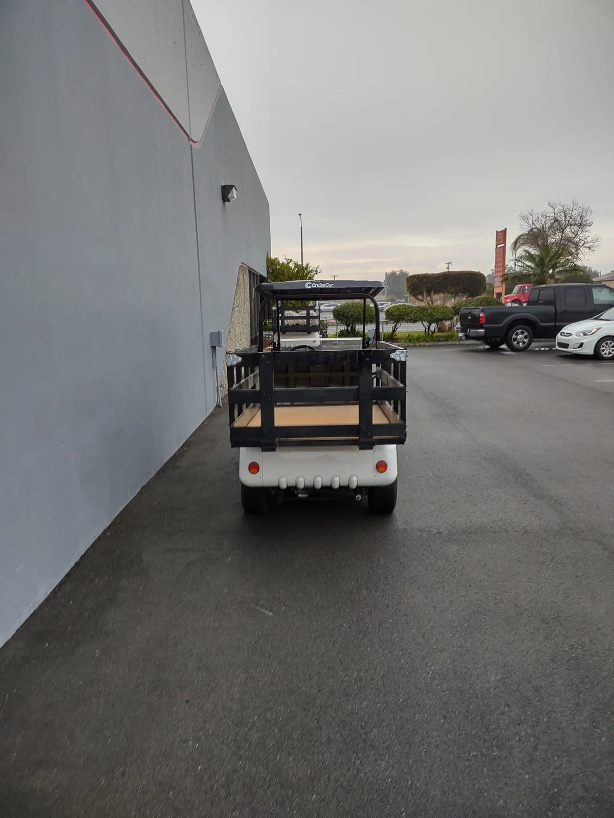 STAKE-SIDES-44X72X24 Flatbed Golf Cart Stake Sides installed on a black flatbed golf cart, showcasing custom fabrication designed for utility cargo and specialty golf cart beds.