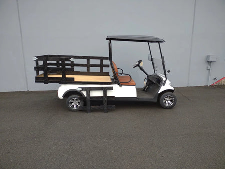 White golf cart equipped with STAKE-SIDES-44X72X24 Flatbed Golf Cart Stake Sides and custom wooden flatbed for cargo and utility hauling.