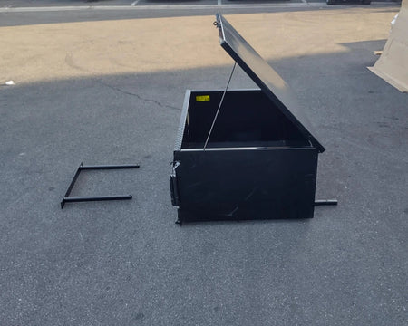 EZGO-RXV-CARGO31 EZ GO RXV HEAVY-DUTY LOCKING CARGO BOX open on pavement showcasing custom fabrication for golf carts with sturdy black metal construction and locking lid.